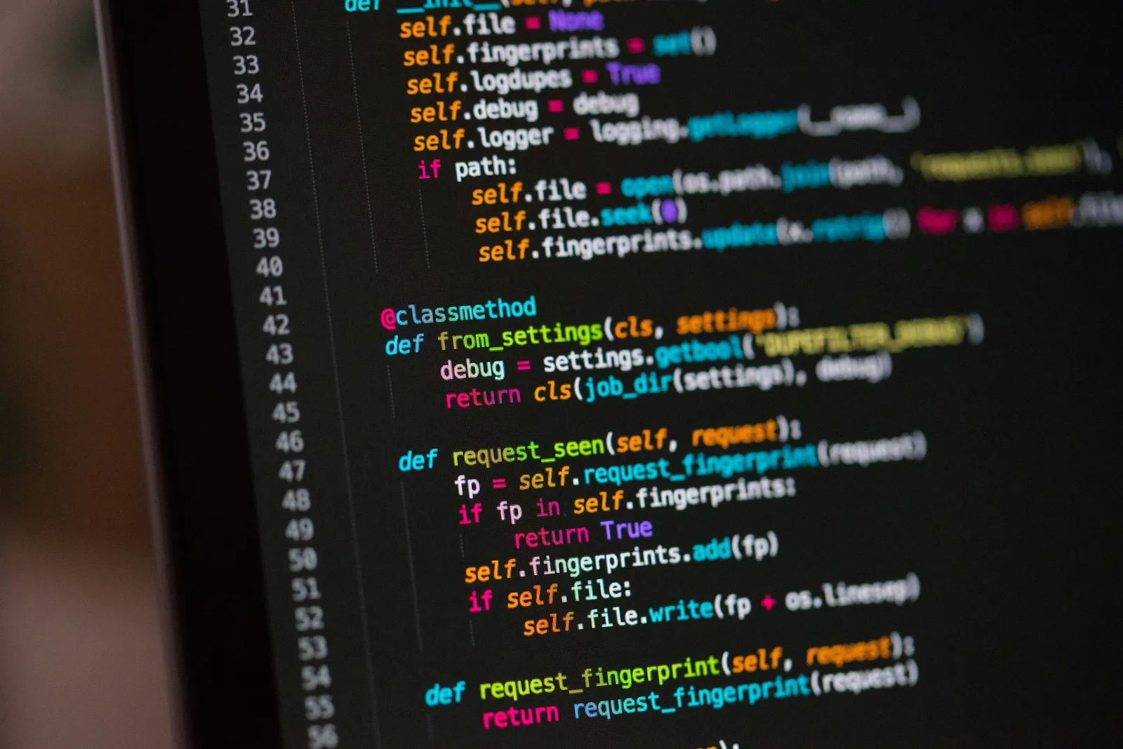 Python code on a monitor, with line numbers and syntax highlighting.